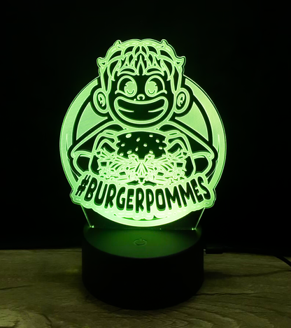 Leuchtende BURGERPOMMES LED-Lampe in kräftigem Grün mit Comic-Figur und Burgermotiv – perfekt als Nachtlicht für Kinderzimmer oder Gaming-Setup.


